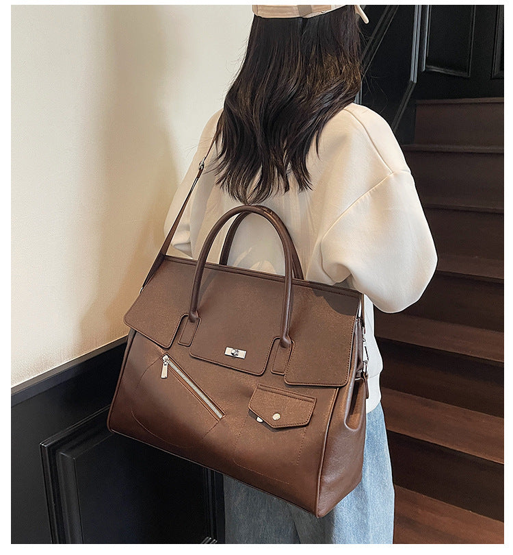 Person holding a brown JOEY Large Faux Leather Multi-use Shoulder Tote Bag 
