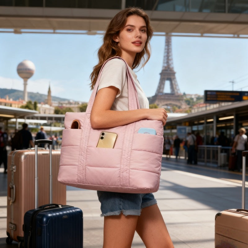 Woman holding a pink DAISY quilted lunch tote bag  with the Eiffel Tower in the background
