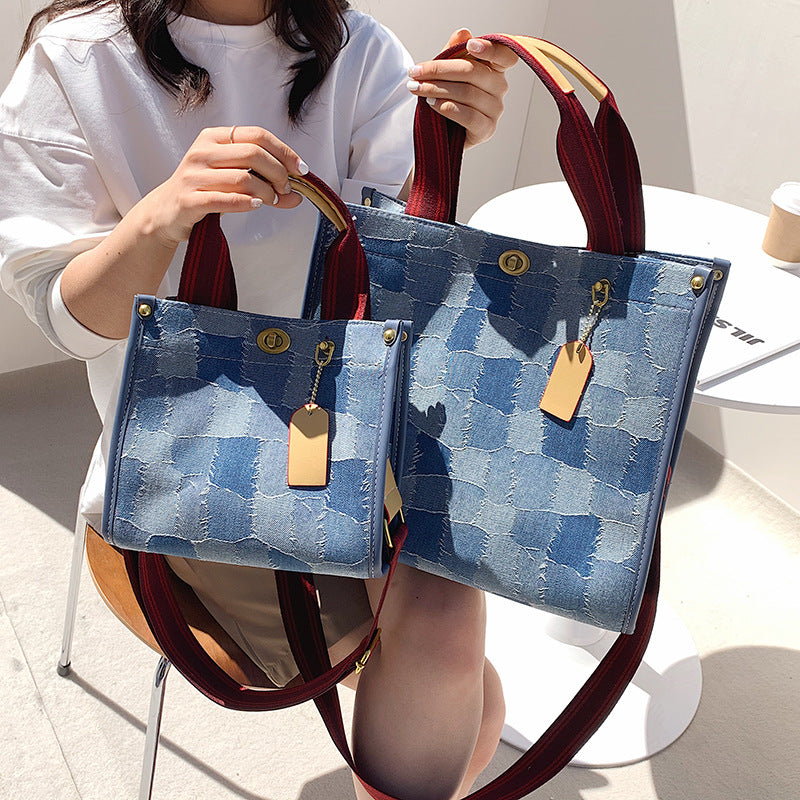 Person holding both middle and large size AMANDA blue denim style patterned tote bag